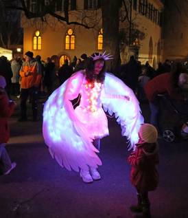 Adventsmarkt 2025 – Engel im beleuchteten Gewand hat Kontakt mit einem Kind Adventsmarkt 2025 – Engel im beleuchteten Gewand hat Kontakt mit einem Kind